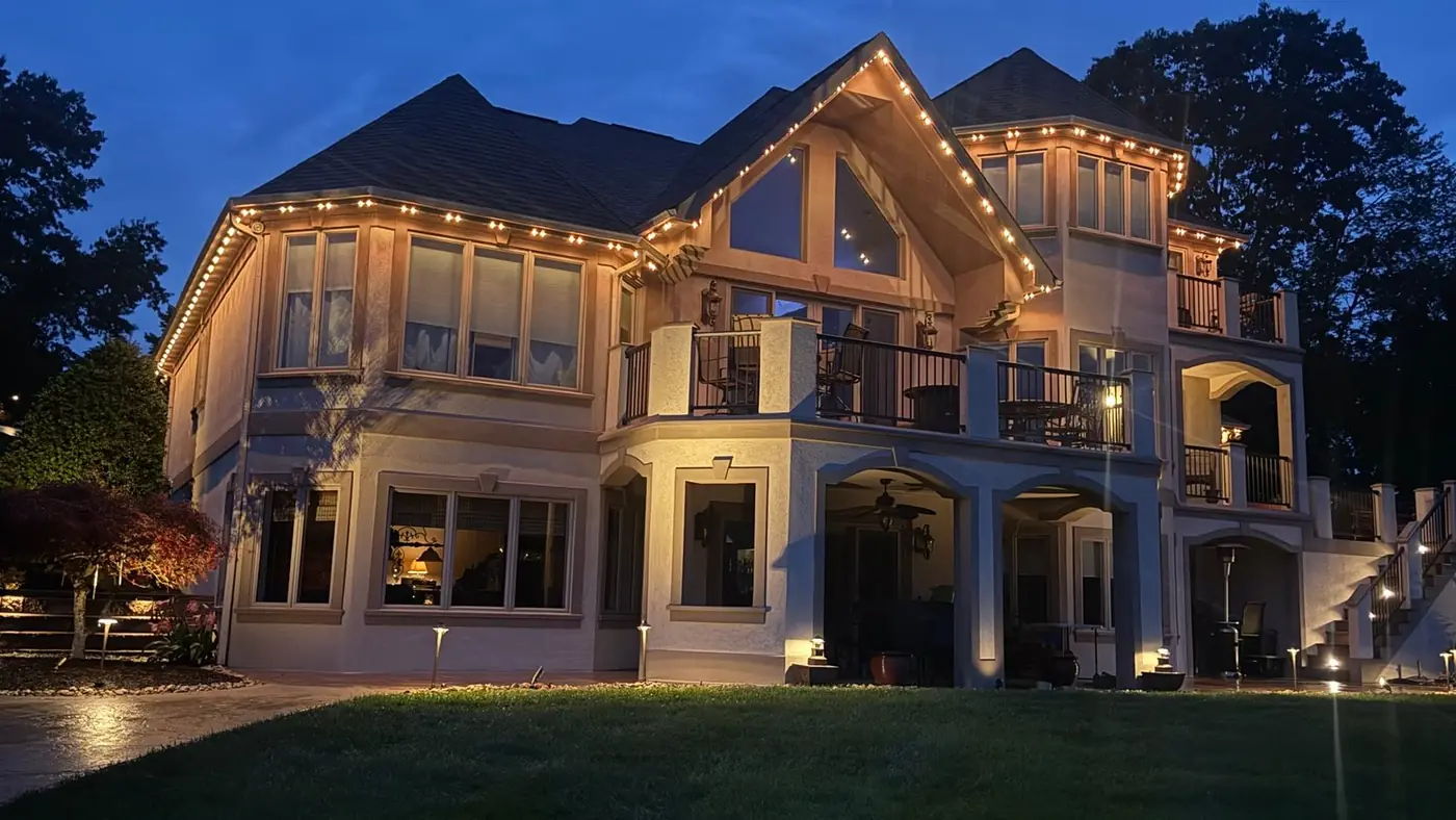 Bright Home Lights permanent track lighting on a home at dusk