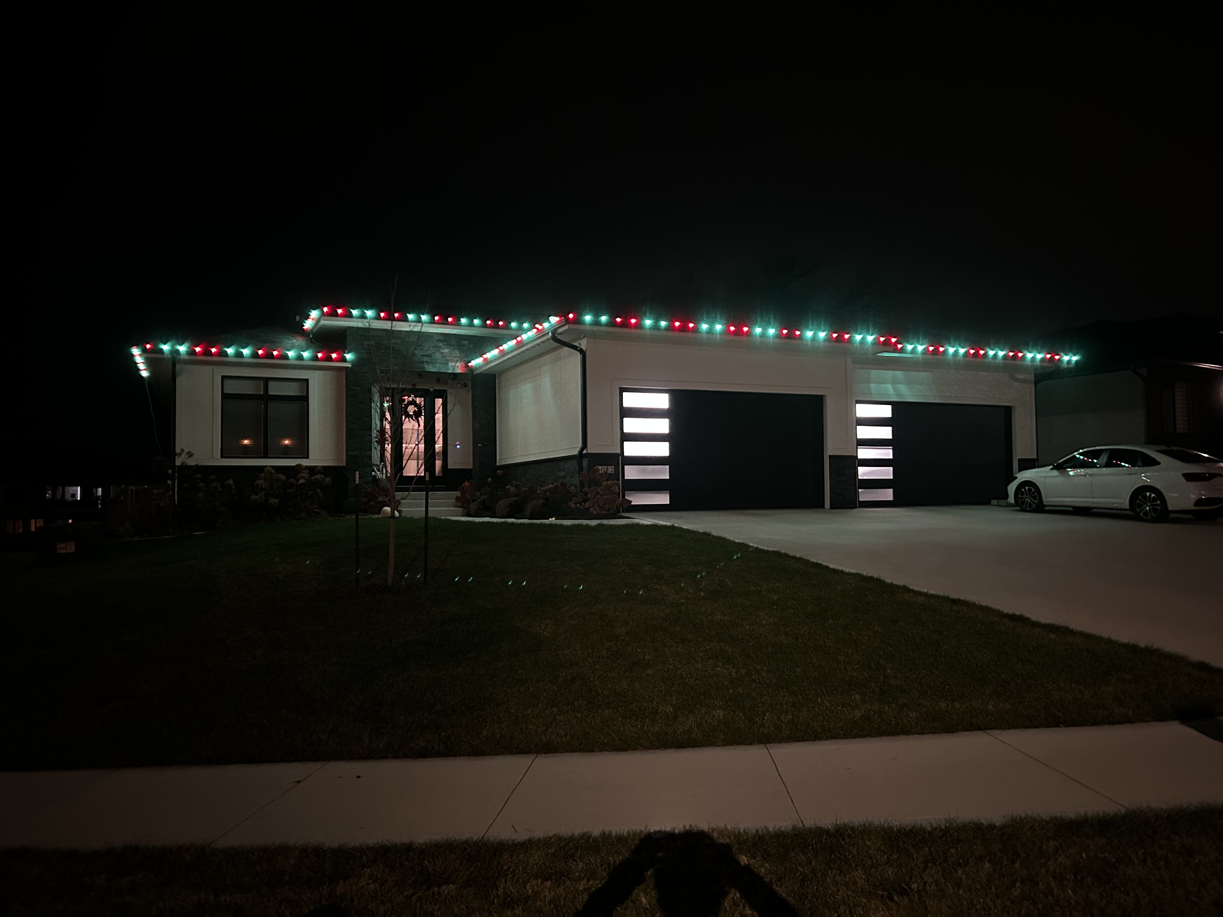 Beautifully lit home with C9 lights along the roofline