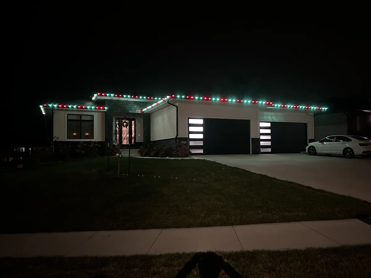 Classic red and green C9 Christmas lights alternating along a Johnston roofline