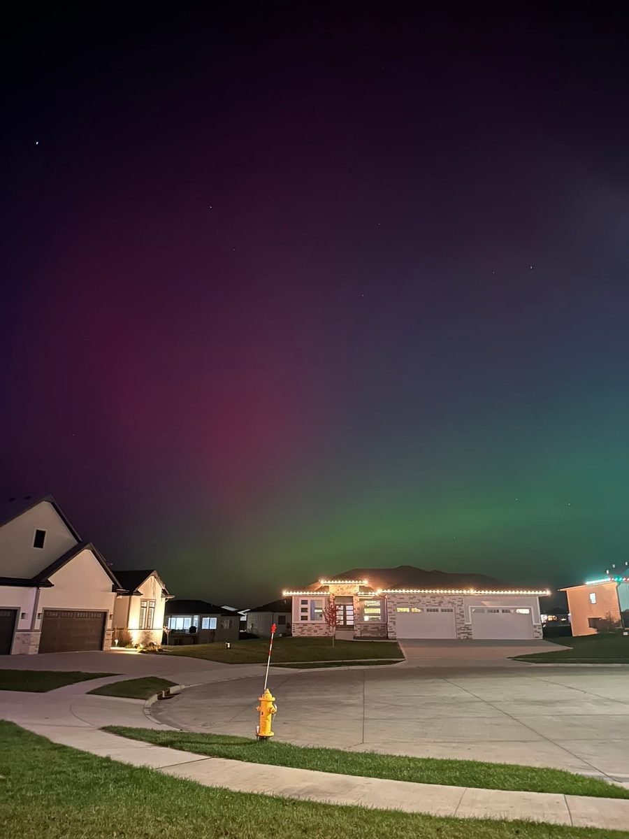 LED C9 bulbs spaced evenly along the eaves and entry gable of a newer suburban home at night