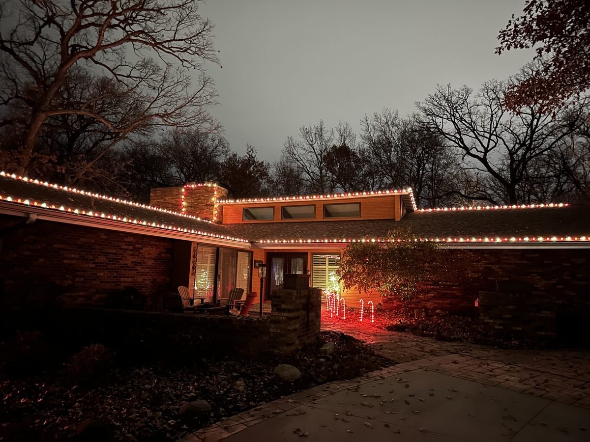 Warm white C9 bulbs cut to fit the eaves, garage peak and front gable of a two story suburban home