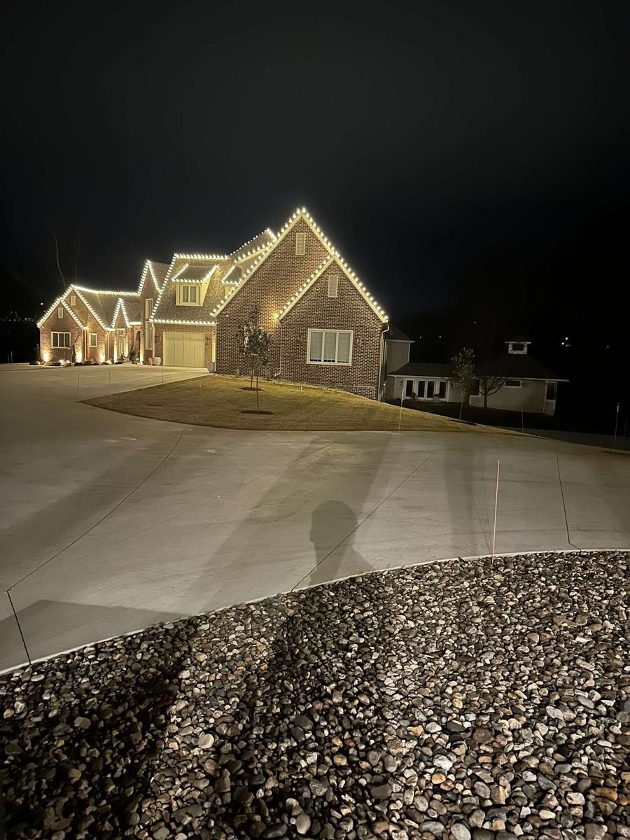 C9 bulbs cut to fit the eaves, porch roof and front gable of a suburban home at night