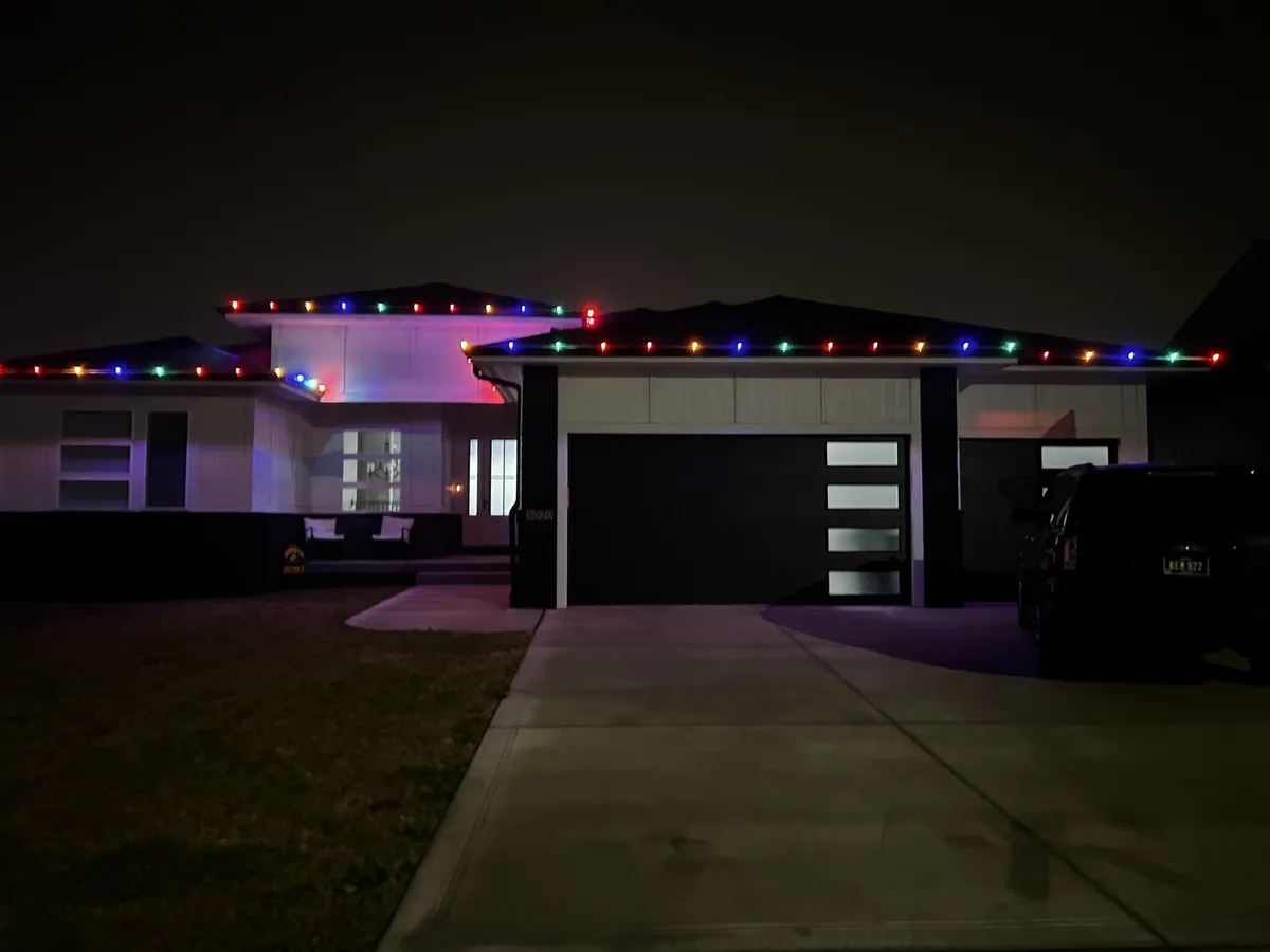 Vibrant multicolor Christmas display running the full roofline of a Clive home