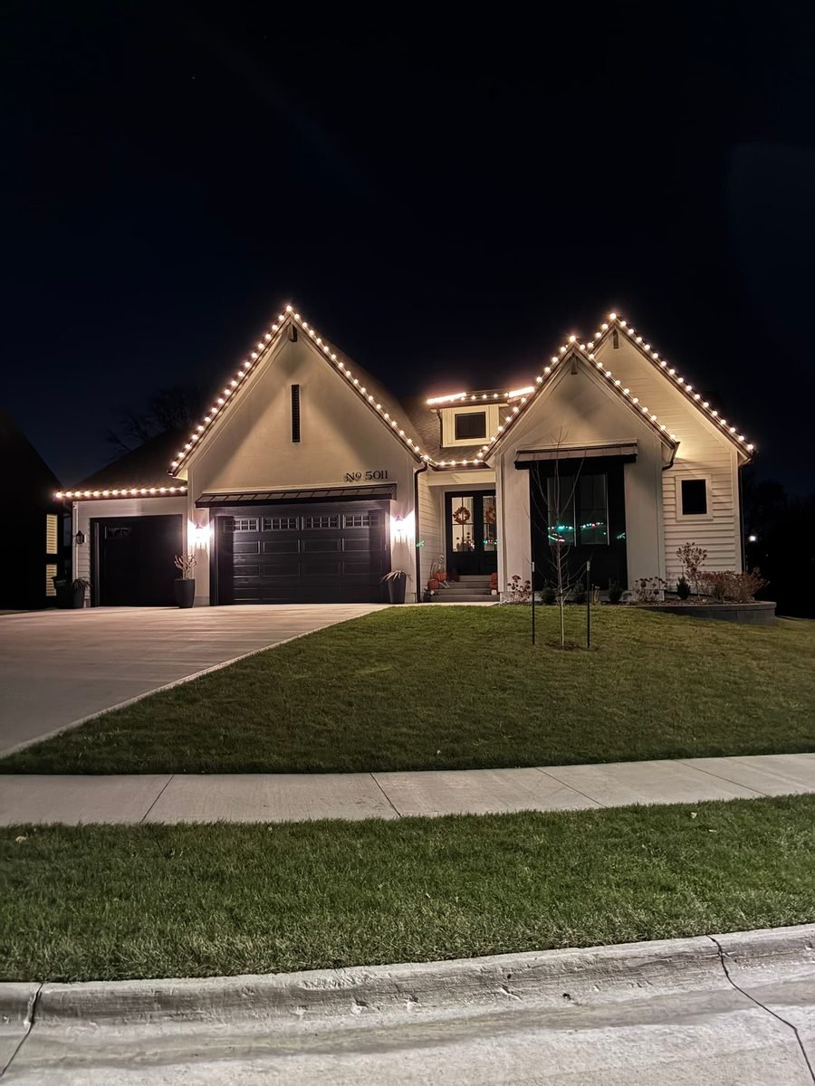 Warm white C9 bulbs running a clean straight line along the front gutter of a home